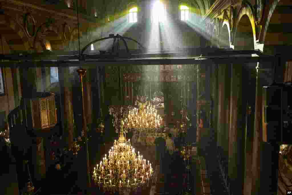 Ecumenical Patriarch Bartholomew I, the spiritual leader of the world&#39;s Orthodox Christians, right, leads the Epiphany Mass at the Patriarchal Church of St. George in Istanbul, Turkey.