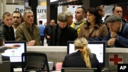 People gather at the airline information desk at of Russian airline Kogalymavia’s desk at Pulkovo airport in St.Petersburg, Russia, Oct. 31, 2015, 