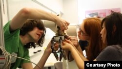 Students in the Mechanical Prototyping class at Olin College work on a robotic hand.