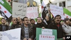 Syrians living in Turkey and human right activists stage a protest outside the Syrian consulate to condemn the latest killings in Syria, in Istanbul, Turkey, Saturday, Feb. 4, 2012. The banners read: "Assad has arms, we have God" and " Syrian Turkmen comm
