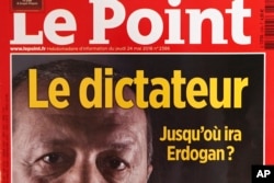 A photo dated May 30, 2018, shows a part of the front cover of French weekly news magazine "Le Point" featuring Turkish President Recep Tayyip Erdogan and the headline "Le dictateur," in Paris, France.