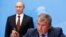 Russia's President Vladimir Putin (back) and Rosneft CEO Igor Sechin attend a signing ceremony at the St. Petersburg International Economic Forum 2014 in St. Petersburg, May 24, 2014.