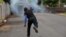 A demonstrator throws a homemade device during the funeral service of Jose Esteban Sevilla Medina, who died during clashes with pro-government supporters in Monimbo, Nicaragua, July 16, 2018.