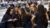 A group of Catholic school girls look at their phones as they wait on the route that Pope Francis will take later in the day near St. Patrick’s Cathedral in New York Sept. 24, 2015.