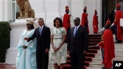 Presiden Obama (melambaikan tangan) dan ibu negara AS Michelle Obama (dua dari kanan) didampingi Presiden Senegal Macky Sall (kanan) dan ibu negara Senegal Mariame Faye Sall,di istana kepresidenan Senegal di Dakar (27/6).