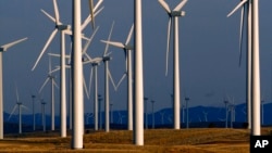FILE - A wind turbine farm owned by PacifiCorp near Glenrock, Wyoming, produces electricity, May 6, 2013.