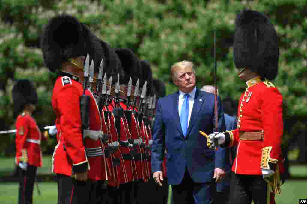 U.S. President Donald Trump inspects an honor guard during a welcome ceremony at Buckingham Palace in central London on the first day of his three-day state visit to the UK.