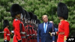 US President Donald Trump inspects an honour guard during a welcome ceremony at Buckingham Palace in central London on June 3, 2019, on the first day of their three-day State Visit to the UK.