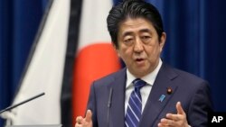 Japanese Prime Minister Shinzo Abe speaks to the media on the eve of the fifth anniversary of the March 11, 2011, earthquake and tsunami, in Tokyo, March 10, 2016. He pledged to bolster reconstruction efforts in northern Japan.