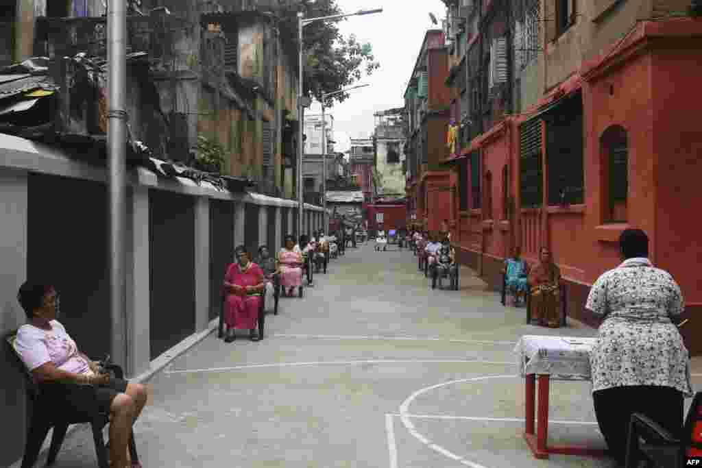 People from an Anglo-Indian community maintain social distance in an open-air area during a special Good Friday prayer, during a government-imposed nationwide lockdown as a preventive measure against the COVID-19 coronavirus, in Kolkata.