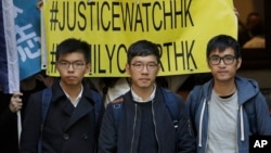 Pro-democracy activists, from left, Joshua Wong, Nathan Law and Alex Chow, walk out of the Court of Final Appeal in Hong Kong, Tuesday, Jan. 16, 2018. (AP Photo/Vincent Yu)