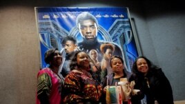 FILE PHOTO: A group of women pose for a photo in front of a poster advertising the film 
