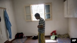 In this Sept. 22, 2011 file photo, a man suspected of being a Gadhafi loyalist prays in a detention facility in Misrata, Libya.