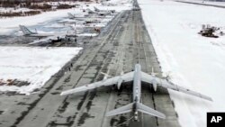 FILE - In this image taken from video provided by the Russian Defense Ministry Press Service, a Tu-95 strategic bomber of the Russian air force prepares to take off from an air base in Engels near the Volga River in Russia, Jan. 24, 2022.