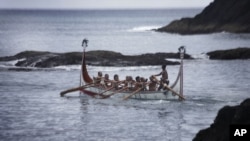 Aboriginal men of the Tao tribe take a newly launched fishing boat on a maiden voyage during a fishing boat launching ceremony on Orchid Island, Taiwan, June 14, 2008.