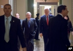 Senate Majority Leader Mitch McConnell, R-Ky., left, and Majority Whip John Cornyn, R-Texas, return to the chamber Dec. 3, 2015, during a marathon series of rapid votes on Capitol Hill in Washington.