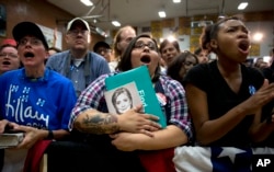 FILE - Supporters call out as Democratic presidential candidate Hillary Clinton speaks during a campaign event at Carl Hayden Community High School in Phoenix, Arizona, March 21, 2016.