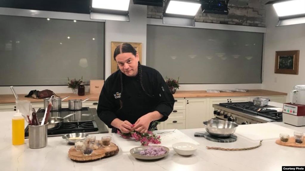 Chef Sean Sherman, a winner of a 2019 James Beard Foundation Leadership Award, preparing apple blossoms. The award acknowledges Sherman's efforts to decolonize the Native American diet. 