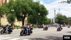 Participants in the Rolling Thunder annual motorcycle rally ride past the National Museum of the American Indian during the parade ahead of Memorial Day in Washington, May 29, 2016. (S. Verma/VOA)