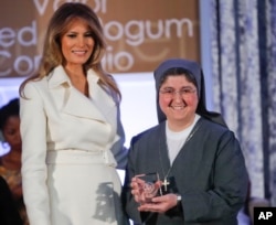 First lady Melania Trump presents the 2017 Secretary's of State's International Women of Courage (IWOC) Award to Sister Carolin Tahhan Fachakh from Syria, March 29, 2017, at the State Department in Washington.