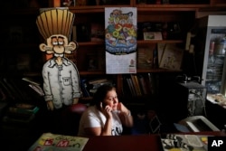 A worker at the office building housing the Turkish satirical cartoon magazine Leman talks on the phone in Istanbul, July 25, 2016. A printed edition about the failed coup attempt was prevented from being distributed last week by Turkish authorities.