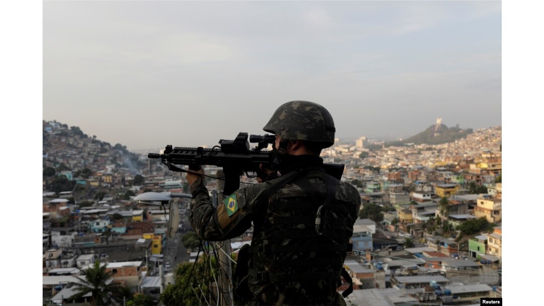 A Brazilian soldier patrols at Chatuba slum during an operation against drug dealers in Rio de Janeiro, Brazil, Aug. 22, 2018.