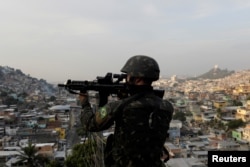 A Brazilian soldier patrols at Chatuba slum during an operation against drug dealers in Rio de Janeiro, Brazil, Aug. 22, 2018.