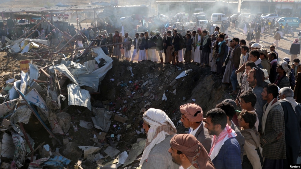 People gather at the site of an air strike in the northwestern city of Saada, Yemen, Nov. 1, 2017. 