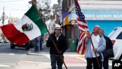 Members of the Mexican Association of Perth Amboy carry flags while taking part in an immigration protest, in Perth Amboy, New Jersey, Feb. 16, 2017.
