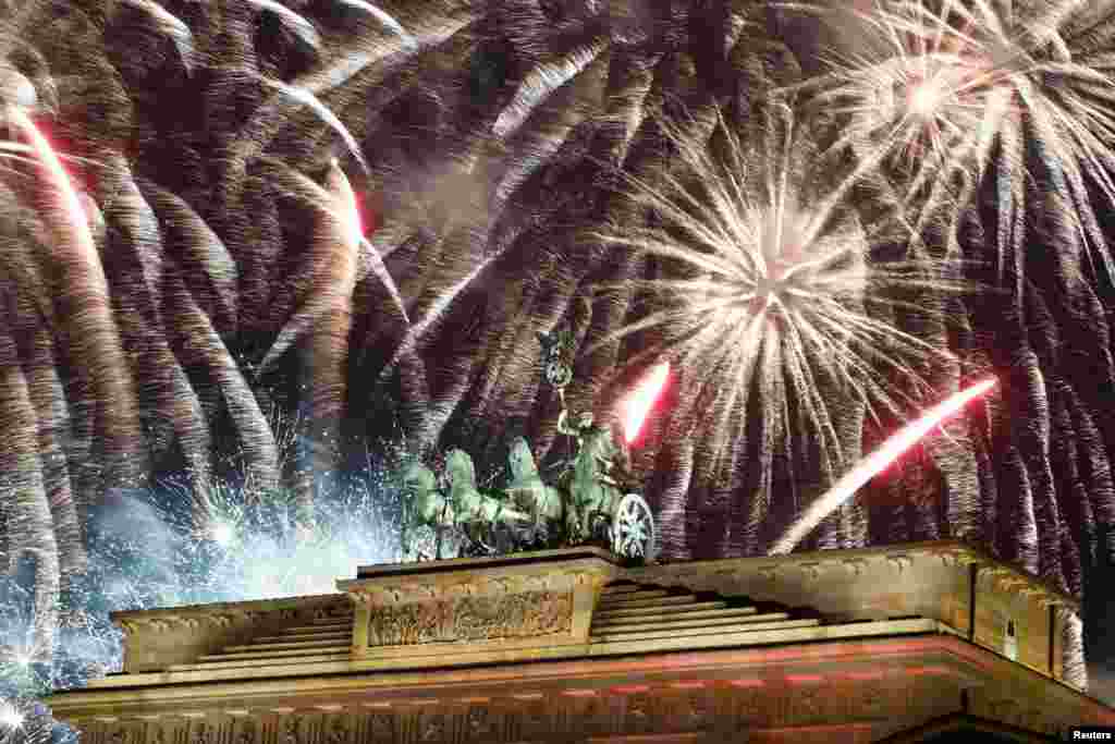 Fireworks explode over the Quadriga sculpture atop the Brandenburg gate during New Year celebrations in Berlin, Germany, Jan. 1, 2019.