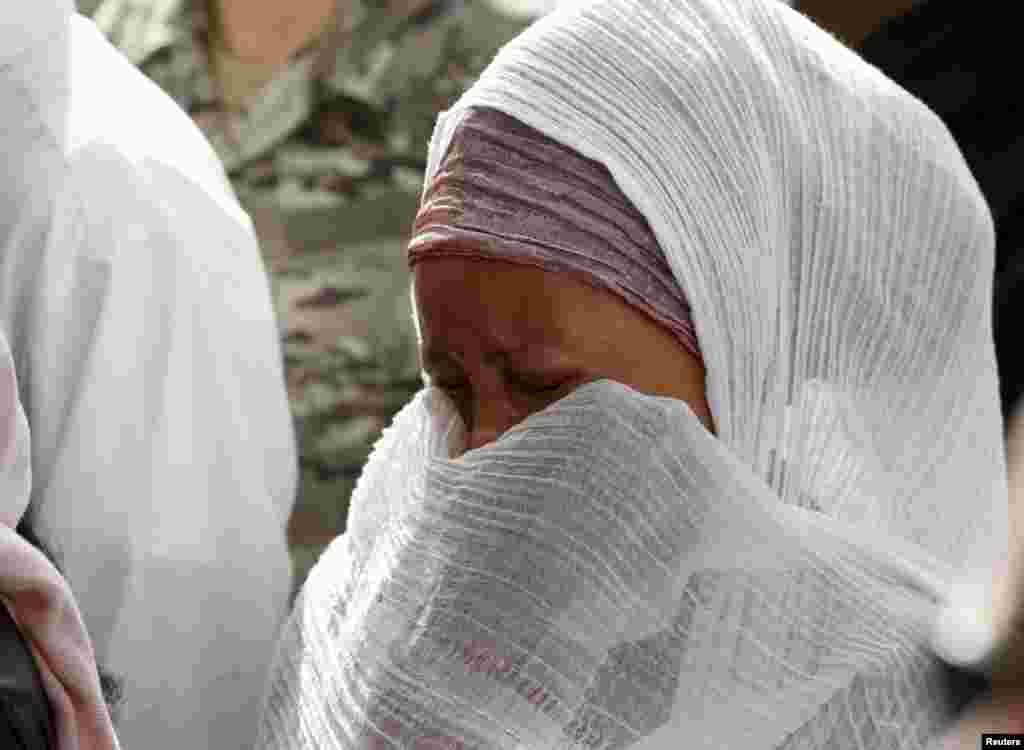 A migrant cries during an interfaith burial service for the victims of the capsized ship, at Mater Dei Hospital in Tal-Qroqq, outside Valletta, April 23, 2015.