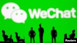 FILE - Small toy figures are seen in front of WeChat logo in this illustration picture taken March 15, 2021. (REUTERS/Dado Ruvic/Illustration)