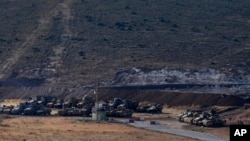 Turkey's tanks and vehicles hold positions close to the border with Syria, Oct. 9, 2017. Turkey's military said Monday that Turkish troops moved into Syria's northwestern Idlib province as part of an operation to enforce a de-escalation zone that was inte