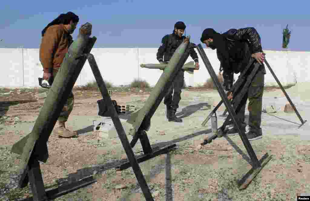 Fighters from the Free Syrian Army's Saif al-Umayyad brigade prepare rockets to be launched towards forces loyal to Syria's President Bashar al-Assad in the eastern Damascus suburb of Ghouta, Jan. 16, 2014. 