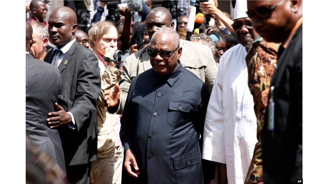 Malian President Ibrahim Boubacar Keita returns to his car after addressing reporters outside the Radisson Blu hotel in Bamako, Mali, Nov. 21, 2015.