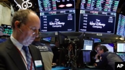 The logo for The Walt Disney Company appears above trading posts on the floor of the New York Stock Exchange, May 14, 2019. Disney is taking full control of Hulu, extending the reach of its streaming abilities.