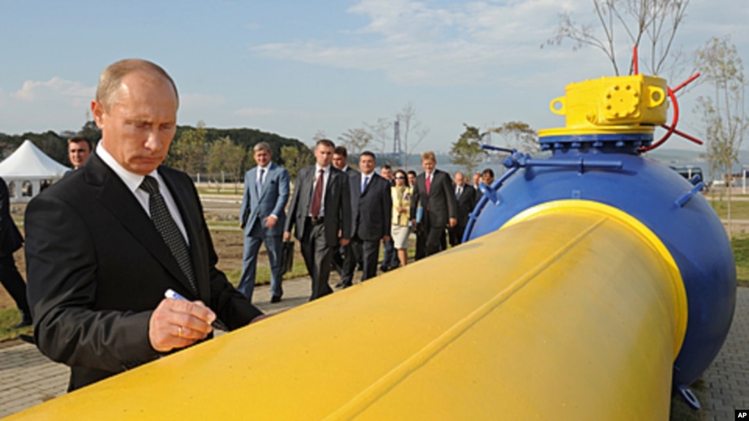 FILE - Vladimir Putin, who then was Russia's prime minister, autographs a natural gas pipeline in the Russian Far East city of Vladivostok during the pipeline's launch ceremony, Sept. 8, 2011. A contract allowing Russian gas to transit across Ukraine expired Dec. 31, 2024. 