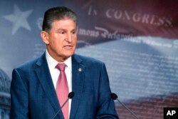 FILE - Sen. Joe Manchin, D-W.Va., speaks with reporters during a news conference on Capitol Hill, Nov. 1, 2021.