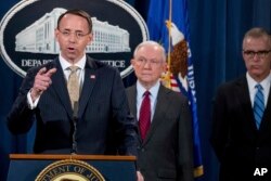 FILE - Deputy Attorney General Rod Rosenstein, left, accompanied by Attorney General Jeff Sessions, center, and FBI Acting Director Andrew McCabe, right, speaks at a news conference in Washington, July 20, 2017.