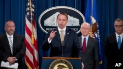 Deputy Attorney General Rod Rosenstein, center, accompanied by DEA Deputy Administrator Robert Patterson, left, Attorney General Jeff Sessions, second from right, and FBI Acting Director Andrew McCabe, right, speaks at a news conference to announce an international cybercrime enforcement action at the Department of Justice, July 20, 2017, in Washington. 