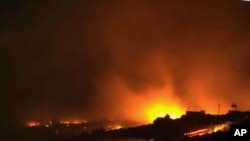 A glow of a large fire seen after an explosion at an ammunition store in Afyonkarahisar in western Turkey, September 6, 2012.