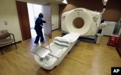 FILE - In this Jan. 9, 2013, photo, a CT scan technician prepares for a patient at the Silver Cross Emergency Care Center in Homer Glen, Ill. The Trump administration is quietly trying to weaken rules regarding exposure to radiation.