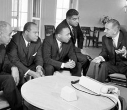 President Johnson talks with civil rights leaders, from left, Roy Wilkins, James Farmer, Dr. Martin Luther King Junior and Whitney Young at the White House in January 1964