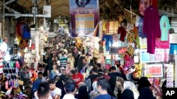 People walk through the old main bazaar in Tehran, Iran, July 23, 2018. 