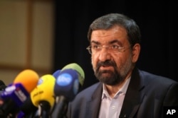 FILE - Mohsen Rezaei, a former chief of Iran's Revolutionary Guard, a hopeful for the upcoming presidential election, speaks during a press conference.