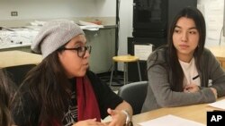 In this photo taken Dec. 1, 2016, Mexican students Yatziri Tovar, left, and Roxanna Herrera, discuss their travel plans at City College of New York.