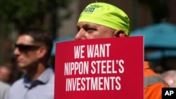 FILE - A rally by U.S. Steel employees is held outside the United Steel Tower in downtown Pittsburgh to display their support for the transaction with Nippon Steel, Sept. 4, 2024.