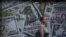 FILE - A woman walks past a currency exchange office in Sao Paulo, Brazil, Jan. 7, 2016.