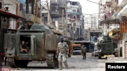 Lebanese army soldiers deployed to tighten security patrol the streets of Tripoli after clashing with Islamist gunmen, northern Lebanon, Oct. 27, 2014.