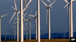 FILE - A wind turbine farm owned by PacifiCorp near Glenrock, Wyoming, cranks out electricity, May 6, 2013.